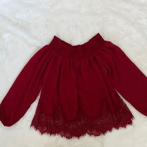 Maroon off the shoulder blouse with lace detailing at the hem